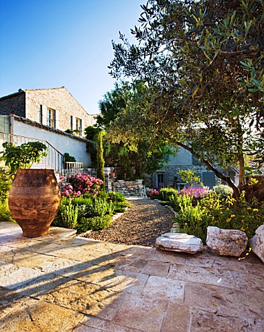 THE_ROU_ESTATE__CORFU_STONE_TERRACE_WITH_OLIVE_TREE_AND_GRAVEL_PATH_WITH_DROUGHTTOLERANT_PLANTING