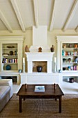 THE ROU ESTATE  CORFU: SITTING/LIVING ROOM WITH RAISED FIREPLACE AND BOOKSHELVES