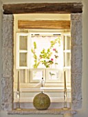 THE ROU ESTATE  CORFU: VIEW THROUGH ALCOVE TO WINDOW WITH FLORAL BLIND AND WOODEN BEAMS