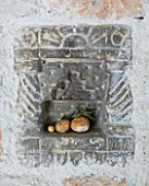 THE ROU ESTATE  CORFU: DETAIL OF DECORATIVE SHELF IN KITCHEN WALL WITH STONE ORNAMENTS AND ROSEMARY