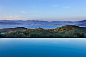 THE KAPARELLI ESTATE  CORFU - VIEW OVER INFINITY SWIMMING POOL OUT TO SEA WITH ALBANIAN MOUNTAINS BEYOND