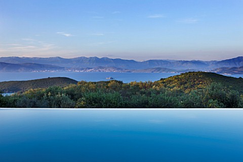 THE_KAPARELLI_ESTATE__CORFU__VIEW_OVER_INFINITY_SWIMMING_POOL_OUT_TO_SEA_WITH_ALBANIAN_MOUNTAINS_BEY