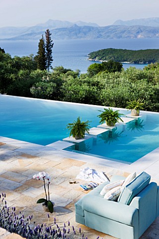 THE_KAPARELLI_ESTATE__CORFU__PATIOSEATING_AREA_WITH_VIEW_OVER_SWIMMING_POOL_OUT_TO_SEA_WITH_ALBANIAN
