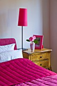 PAULA PRYKES HOUSE  SUFFOLK: BEDROOM DECORATED WITH CERISE PINK FURNISHINGS