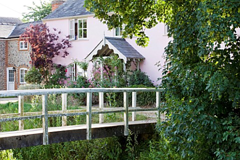 PAULA_PRYKES_HOUSE__SUFFOLK_VIEW_TO_HOUSE_WITH_BRIDGE