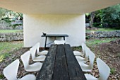 JACQUELINE MORABITO  FRANCE - DINING AREA - WHITE CONCRETE SEATING AREA WITH WOODEN TABLE AND WHITE CHAIRS
