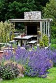 DESIGNER: CLARE MATTHEWS  DEVON - OUTDOOR KITCHEN WITH PIZZA OVEN AND LARGE DINING TABLE
