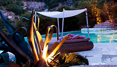 THE_ROU_ESTATE__CORFU__GREECE_DESIGNER_DOMINIC_SKINNER___A_PLACE_TO_SIT__THE_SWIMMING_POOL__LIT_UP_A