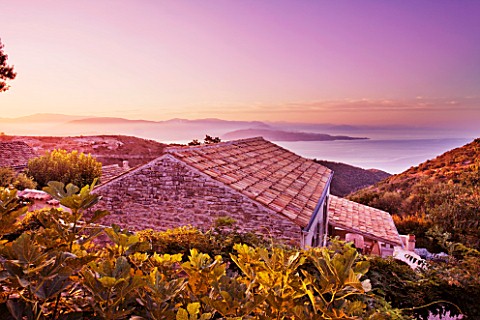 THE_ROU_ESTATE__CORFU__GREECE_DESIGNER_DOMINIC_SKINNER__VIEW_OVER_ROOFTOP_TO_THE_ALBANIAN_MOUNTAINS_