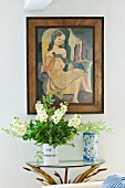 DESIGNER: ANNE FOWLER - THE LIVING ROOM - FLOWERS ON TABLE WITH PICTURE ABOVE