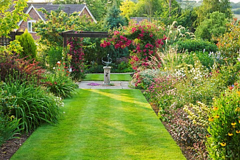 MEADOW_FARM__WORCESTERSHIRE_SUNDIAL_ARBOUR_WITH_ROSA_SUPER_EXCELSA_WITH_LONG_BORDERS_EITHER_SIDE