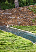 DESIGNER: JEAN-LAURENT FELIZIA  FRANCE: LAWN WITH SWIMMING POOL AND ROCK WALL