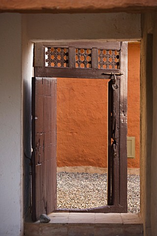 DESIGNERS_ERIC_OSSART_AND_ARNAUD_MAURIERES__MOROCCO_AL_HOSSOUN__DOORWAY_FRAMING_VIEW_INTO_COURTYARD