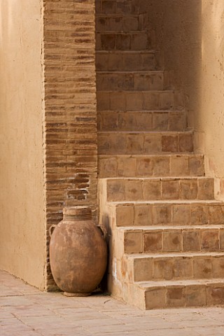 DESIGNERS_ERIC_OSSART_AND_ARNAUD_MAURIERES__MOROCCO_AL_HOSSOUN__TERRACOTTA_CONTAINER_BESIDE_SOME_STE