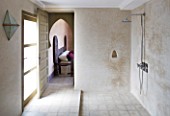 DESIGNERS ERIC OSSART AND ARNAUD MAURIERES  MOROCCO: AL HOSSOUN - SHOWER ROOM AND VIEW TO BEDROOM