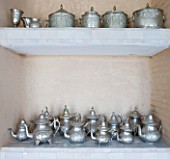DESIGNERS ERIC OSSART AND ARNAUD MAURIERES  MOROCCO: AL HOSSOUN - SHELVES IN LIVING ROOM WITH TEAPOTS