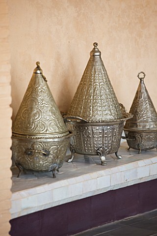 DESIGNERS_ERIC_OSSART_AND_ARNAUD_MAURIERES__MOROCCO_AL_HOSSOUN__METAL_CONTAINERS_ON_SHELF_IN_LIVING_