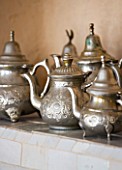 DESIGNERS ERIC OSSART AND ARNAUD MAURIERES  MOROCCO: AL HOSSOUN - TEAPOTS ON SHELF IN LIVING ROOM