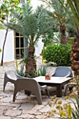 DESIGNERS ERIC OSSART AND ARNAUD MAURIERES  MOROCCO: AL HOSSOUN - A PLACE TO SIT - LOW TABLE AND CHAIRS ON PATIO/ TERRACE/ COURTYARD