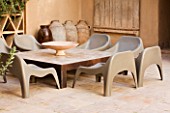 DESIGNERS ERIC OSSART AND ARNAUD MAURIERES  MOROCCO: AL HOSSOUN - A PLACE TO SIT - LOW TABLE AND CHAIRS ON PATIO/ TERRACE/ COURTYARD