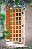DESIGNERS ERIC OSSART AND ARNAUD MAURIERES  MOROCCO: AL HOSSOUN - WOODEN DOOR IN WALL