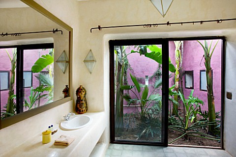 DESIGNERS_ERIC_OSSART_AND_ARNAUD_MAURIERES__MOROCCO_AL_HOSSOUN__BATHROOM_WITH_VIEW_OUT_TO_GARDEN_WIT