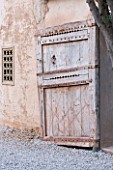 DESIGNERS ERIC OSSART AND ARNAUD MAURIERES  MOROCCO: DAR IGDAD - AN OLD DOOR BESIDE THE WALL