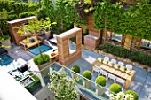 MODERN ROOF GARDEN BY STEPHEN WOODHAMS, LONDON: CEDARWOOD SCREEN, MIRROR, TABLE, CHAIRS, CLIPPED, TOPIARY, PLEACHED, HORNBEAMS, CONTEMPORARY, BOX BALLS IN CERAMIC CONTAINERS, CORNUS KOUSA, TERRACE, BALCONY