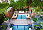 MODERN ROOF GARDEN BY STEPHEN WOODHAMS, LONDON: CEDARWOOD SCREEN, MIRROR, TABLE, CHAIRS, CLIPPED, TOPIARY, PLEACHED, HORNBEAMS, CONTEMPORARY, BOX BALLS IN CERAMIC CONTAINERS, CORNUS KOUSA, TERRACE, BALCONY, DECKING, DECKED, DECKS