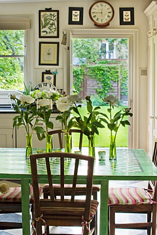 DESIGNER_BUTTER_WAKEFIELD__LONDON_THE_KITCHEN_WITH_LINE_OF_GREEN_VASES_WITH_WHITE_PEONIES_FROM_COVEN