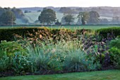 SANDHILL FARM HOUSE  HAMPSHIRE - DESIGNER ROSEMARY ALEXANDER: GRASS BORDER WITH VIEWS OUT TO THE COUNTRYSIDE