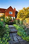 SANDHILL FARM HOUSE  HAMPSHIRE - DESIGNER ROSEMARY ALEXANDER: VIEW TO THE HOUSE ALONG A PATH EDGED WITH ALCHEMILLA MOLLIS AND ROSA GALLICA VERSICOLOR