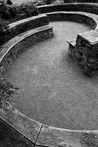 RHS_GARDEN__ROSEMOOR__DEVON_BLACK_AND_WHITE_IMAGE_OF_A_SEATING_AREA_IN_THE_FOLIAGE_GARDEN