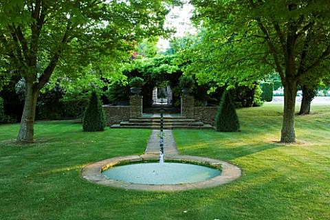 PRIVATE_GARDEN_COTSWOLDS_DESIGNER_ALISON_HENRY__LAWN_AND_RILL_TO_FORMAL_ROUND_POND__POOL__LAWN_STONE