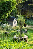 DESIGNER ALISON HENRY - PRIVATE GARDEN, COTSWOLDS: MEADOW WITH DRYSTONE PLANTER TREE SEATS AND WENDY HOUSE - ENGLISH GARDEN, CLASSIC, COUNTRY