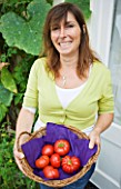 DESIGNER CLARE MATTHEWS: CLARE HARVESTING TOMATOES IN HER CONSERVATORY
