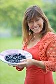 DESIGNER CLARE MATTHEWS: CLARE HOLDING A BOWL OF BLUEBERRIES