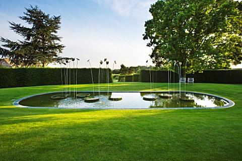 WHATLEY_MANOR__WILTSHIRE_THE_LOGGIA_GARDEN_WITH_LAWN__POOL_AND_WATER_FEATURE_BY_SIMON_ALLISON