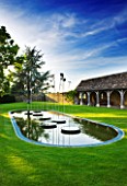 WHATLEY MANOR  WILTSHIRE: THE LOGGIA GARDEN WITH COTSWOLD STONE LOGGIA BUILDING  LAWN  POOL AND WATER FEATURE BY SIMON ALLISON