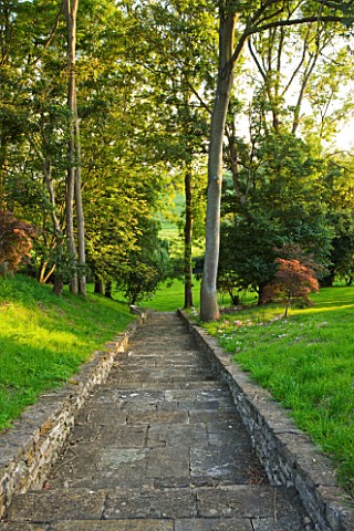WHATLEY_MANOR__WILTSHIRE_STEPS_LEADING_DOWN_TO_THE_RIVER__THE_SHERSTON_AVON