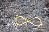 DIGNE-LES-BAINS  FRANCE: GOLD INFINITY SIGN IN ROCK BY HERMAN DE VRIES