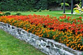 VILLA GIUSEPPINA  LAKE COMO  ITALY  - RAISED BED PLANTED WITH BEDDING BESIDE THE LAWN
