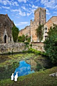 NINFA GARDEN, GIARDINI DI NINFA, ITALY: LARGE POOL / POND WITHIN THE CASTLE WALLS WITH THE TOWER. MEDITERRANEAN GARDEN