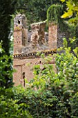 NINFA GARDEN, GIARDINI DI NINFA, ITALY: RUINED BUILDING IN THE GARDEN. WALL, ANCIENT MONUMENT, SUMMER, MEDITERRANEAN GARDEN, ITALIAN GARDEN