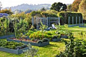 DESIGNER CLARE MATTHEWS: THE FRUIT AND VEGETABLE GARDEN IN DEVON. RAISED  BLUE PAINTED WOODEN BEDS AND ARBOUR