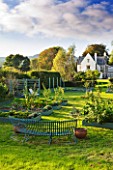 DESIGNER CLARE MATTHEWS: THE FRUIT AND VEGETABLE GARDEN IN DEVON. RAISED  BLUE PAINTED WOODEN BEDS AND ARBOUR  BLUE PAINTED METAL BENCH AND HOUSE