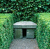 SIMPLE STONE SEAT SET INTO HEDGE IN THE ROSE GARDEN AT BUTTERSTREAM  IRELAND. DESIGNER: JIM REYNOLDS