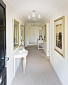MODERN HALLWAY WITH SIDE TABLE AND PICTURES ON WALLS