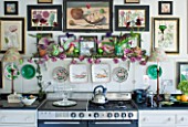 DESIGNER BUTTER WAKEFIELD  LONDON - THE KITCHEN WITH BOTANICAL PRINTS ABOVE THE COOKER