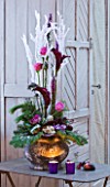 DESIGNER: JACKY HOBBS  LONDON: THE LIVING ROOM AT CHRISTMAS WITH CONTAINER ON METAL TABLE WITH BEAUTIFUL DISPLAY OF FLOWERS